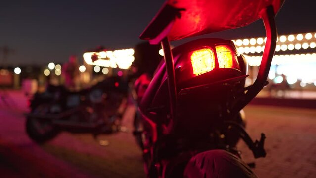 A motorcycle parked on the side of the road at night