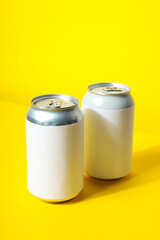 Tin cans for drinks on a yellow background