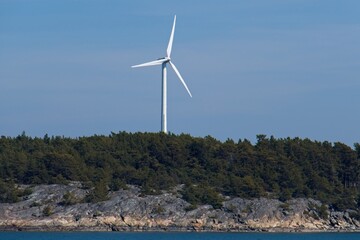 Windmill in forest in sunny summer weather.