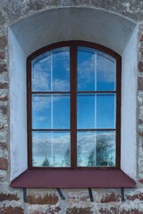 Old wood framed window on a stone building.