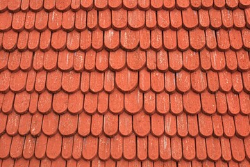 Red painted wood roof shingles in horizontal orientation.