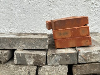 Stack of gray bricks with a few brown ones on top