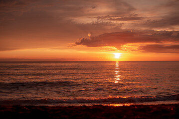Beautiful view of the sea sunset. Orange evening sky.