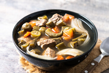 Traditional African okra soup on wooden table