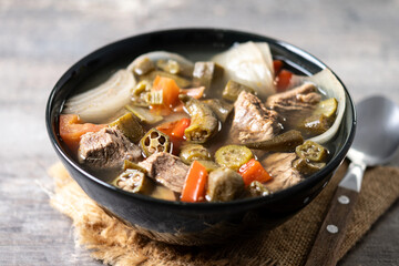 Traditional African okra soup on wooden table