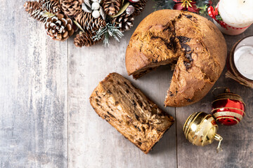 Christmas panettone cake with chocolate chips on wooden table. Top view. Copy space