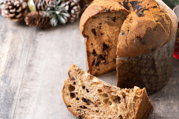 Christmas panettone cake with chocolate chips on wooden table. Copy space