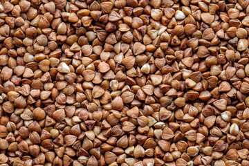 Buckwheat groats in bulk, grains close-up, background
