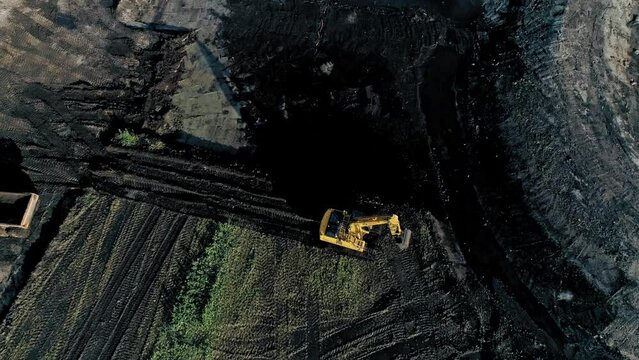 Excavator and dumper working in the field