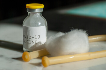 Sars-cov-2 vaccine vial bottle on marble table.