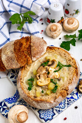 Potato soup with mushrooms in a loaf of bread.