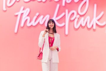 Stylish woman with trendy accessories looking at camera