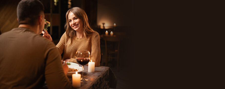 Caucasian couple in love drinking wine from glasses and eating italian food at home 14 february, Celebrating valentine's day