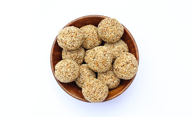 Indian sweet sesame laddu or til laddu in a wooden bowl top view 