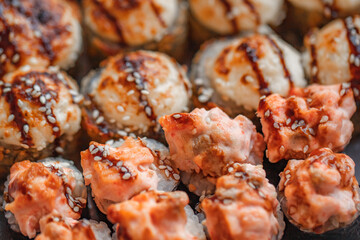 Sushi rolls baked with sesame seeds in nori, close-up, selective focus