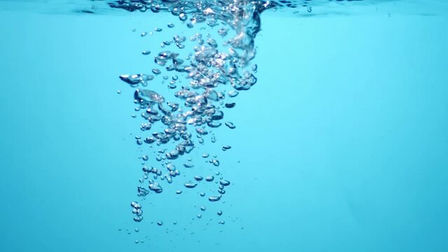 Air bubbles in water on a blue background