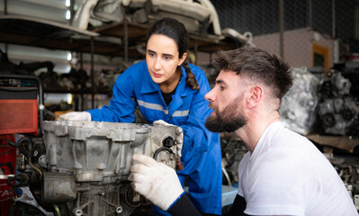 Two men repairing car engine in auto repair shop, Selective focus.