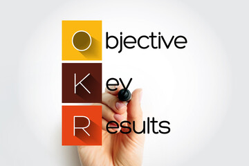 OKR Objective Key Results - goal setting framework used by individuals, teams, and organizations to define measurable goals and track their outcomes, acronym text concept background