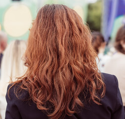 Red wavy hair on a girl as a background
