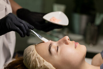 Fractional mesotherapy. A young beautiful woman in the cosmetologist’s office receives fractional...