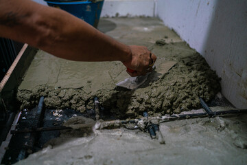 Mechanical man hand plaering cement interior floor building