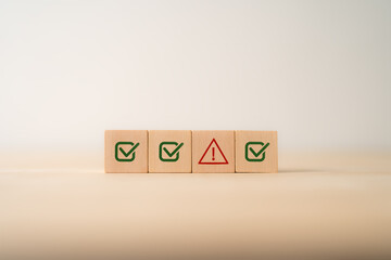 Problem and error warning concept. Wooden cubes with triangle caution warning sign, warning system...
