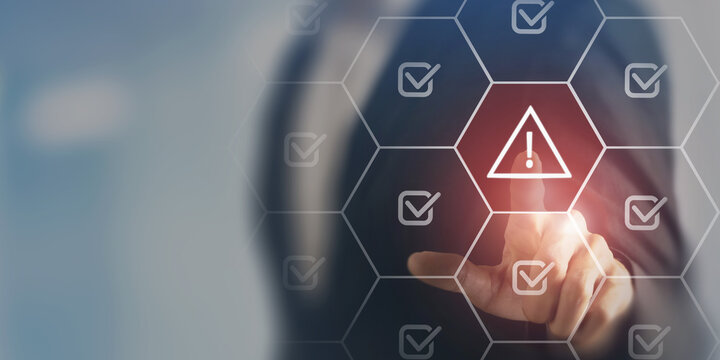 Problem and error warning concept. Businessman touching on triangle caution warning sign, automatic warning system for notification error and maintenance. Incident, risk, contingency management.