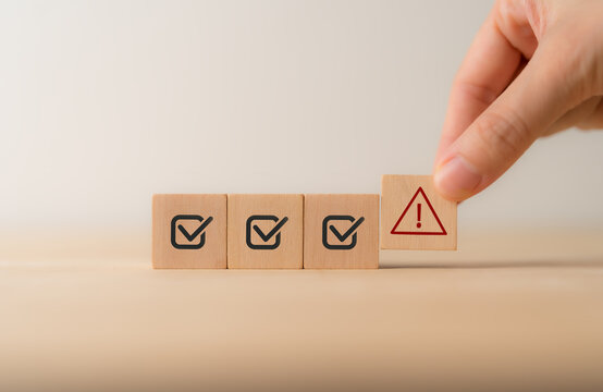Problem and error warning concept. Wooden cubes with triangle caution warning sign, warning system for notification error and maintenance. Incident, risk, contingency management. Proactive approach.