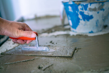 Mechanical man hand plaering cement interior floor building