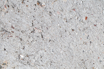 Cement plaster rough with streaks and inclusions close-up background