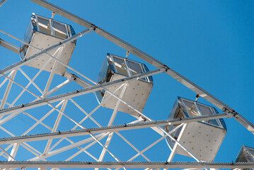White big city ferris wheel on a background of blue sky	