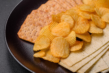 Crispy potato chips with salt, spices and herbs
