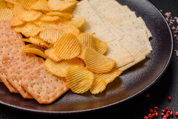 Crispy potato chips with salt, spices and herbs