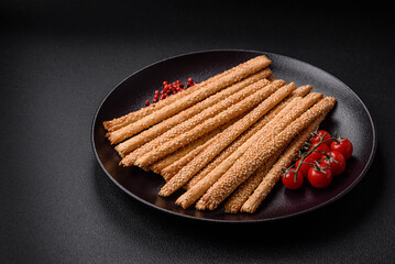 Delicious fresh grissini sticks with salt and sesame seeds