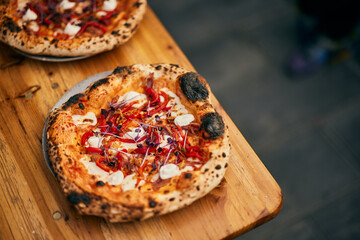 Good-looking pizza served on a plate, top view.