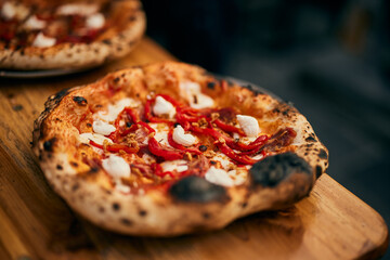 A baked Napoletana pizza, looking delicious, right from the oven, full of toppings.