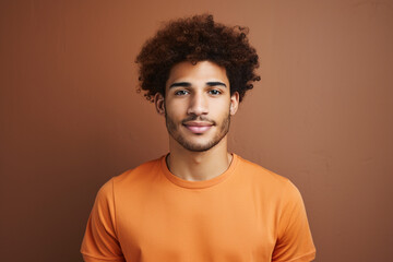 Fototapeta na wymiar Freckled Fro: Man Flaunts Curly Afro Hairstyle in Studio Setting