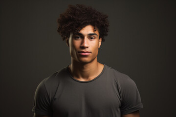 Studio Stunner: Curly-Haired Man with Freckles Strikes a Pose