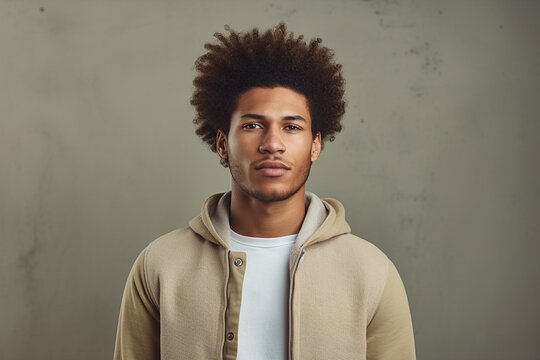 Freckled Fro: Man Flaunts Curly Afro Hairstyle in Studio Setting