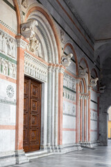 Fototapeta na wymiar Main door of Lucca Cathedral. It is a Roman Catholic cathedral dedicated to Saint Martin of Tours in Lucca, Tuscany, Italy. The doors of the church are closed and no one is there.