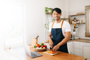 Man hands preparing a healthy salad. Cutting vegetables tomatoes on a cutting board