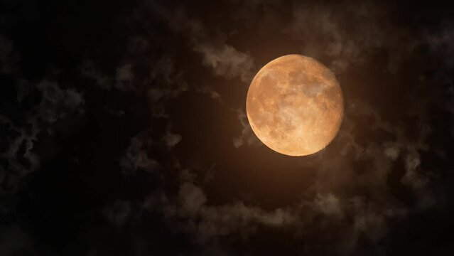Full bright moon with craters behind moving clouds and small streams of rising warm air close up. Space exploration, astrology, telephoto photography, natural satellite of Earth