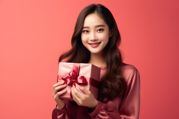 Fototapeta premium Cute girl Standing in christmas light background, unboxing a christmas present, Christmas and Happy new year surprise gift unboxing