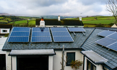 Solar panels on a roof looking out over a rural setting.
