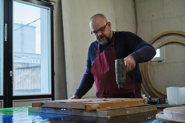 Pouring resin into a wooden mold, a moment of creation. Taps into the trend of combining nature...