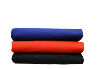 Folded colorful merino wool sweaters on isolated background