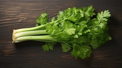 Photo of fresh green celery lying on a wooden table