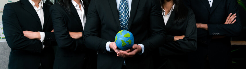 Group of business people standing in line holding paper globe as environmental awareness campaign...