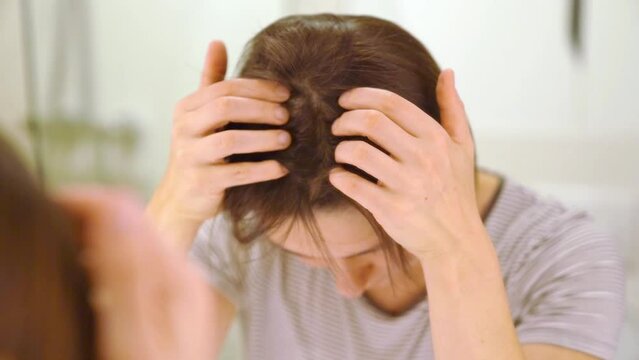 Hair loss concept - female massages sculp fot better hair growth