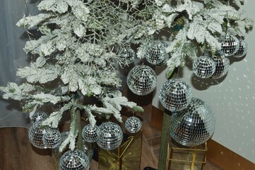 Part of a Christmas tree - branches with frost and silver mirror balls.
